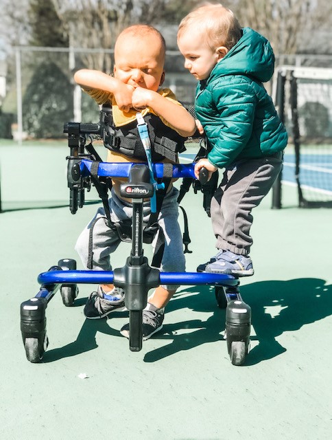The Berry boys play together outside as Nolan practices walking in his gait trainer.