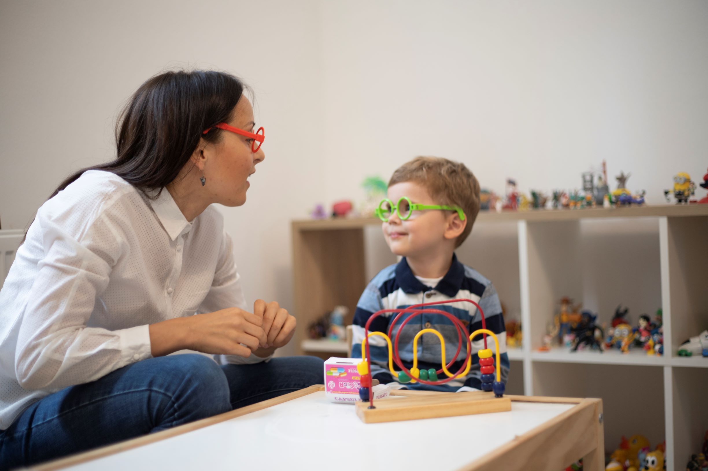 Three years old boy having a play therapy session with the psychotherapist.