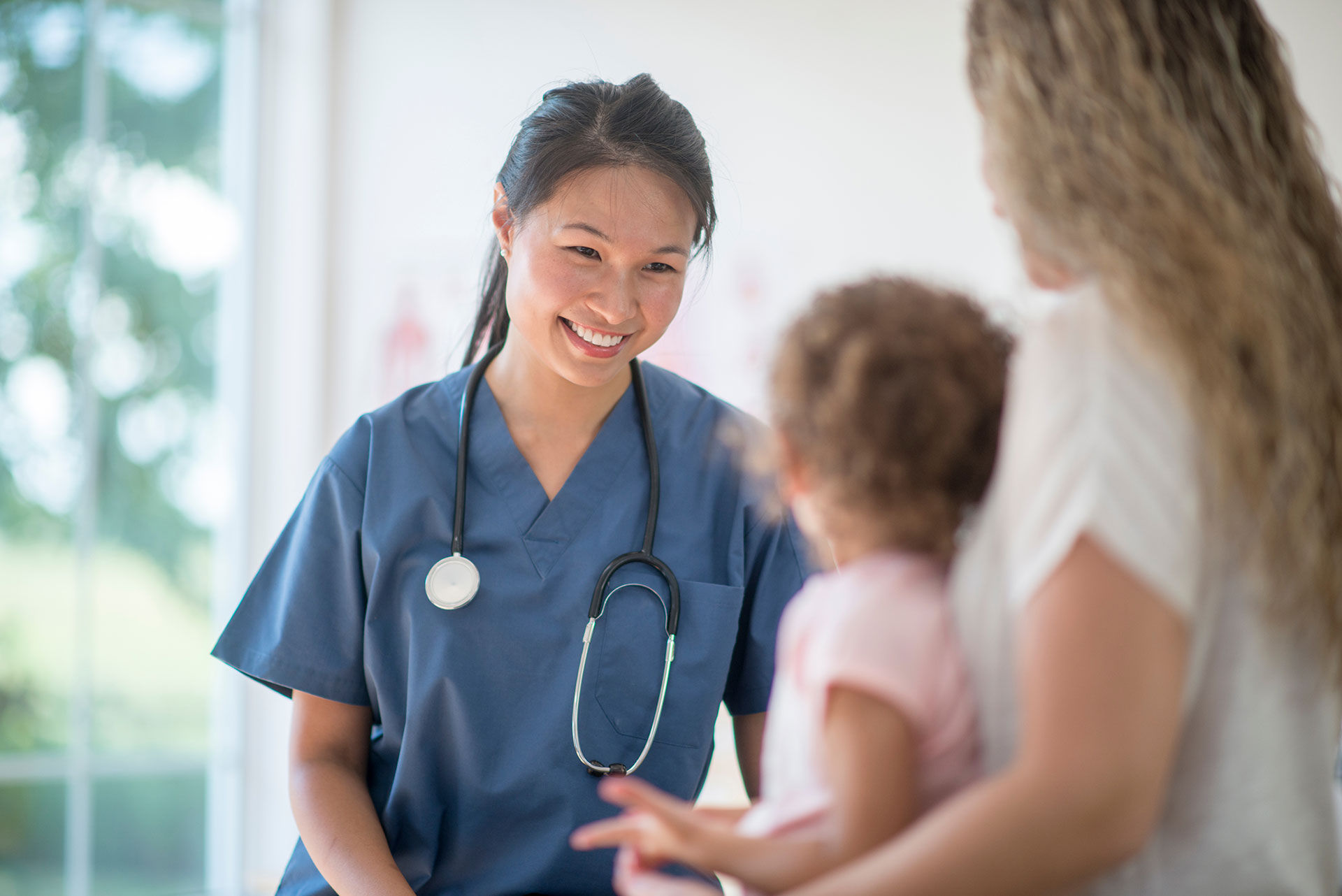 female nurse helps pediatric patient