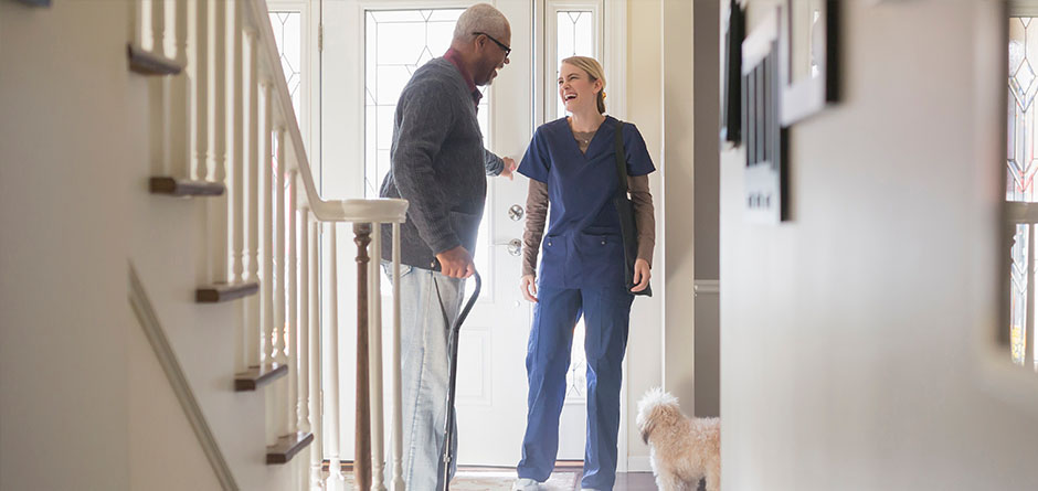 nurse and in home care patient talk in the hallway