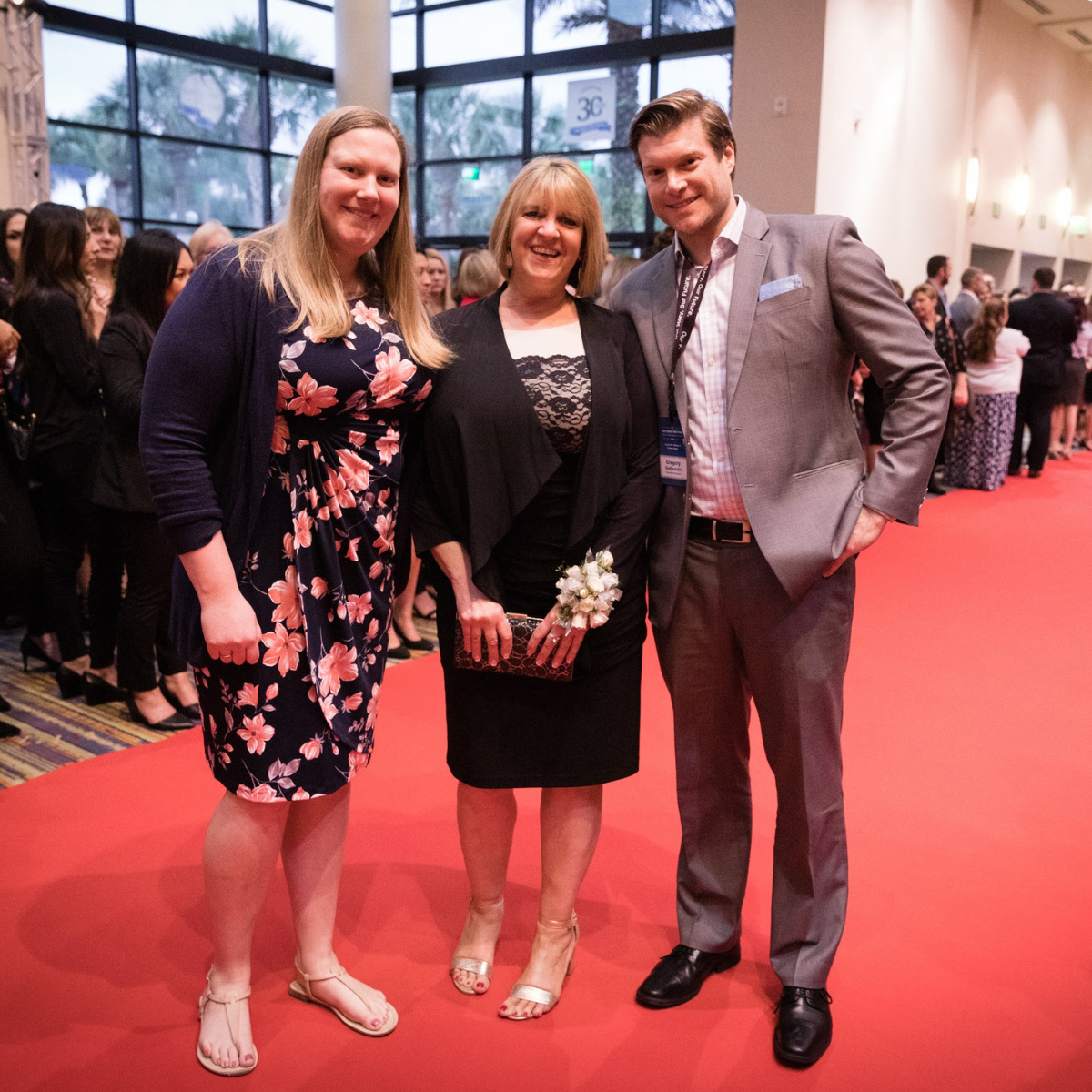 three maxim employees at the caregiver of the year event