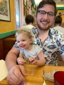 Tyler Carlin and his baby daughter at a table