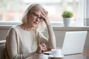 Woman sitting on table with her laptop