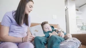 Nurse reading story to an admitted kid