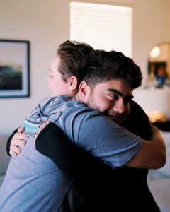 Caitlin Drumel hugging client