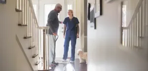 Home healthcare nurse greeting patient at the door for in-home medical visit