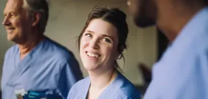 Smiling nurse in scrubs representing the compassionate team at Maxim Healthcare