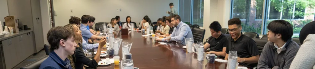 Photo of people working at a large conference table